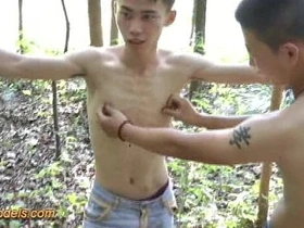 Asian boy tied up outdoors for some fun