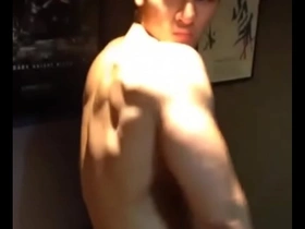 Young Asian man showing off his muscles.