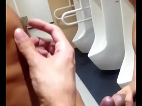 Gay Asian man masturbates in public restroom
