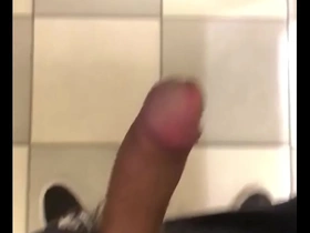 Young Asian man masturbates in the mall bathroom