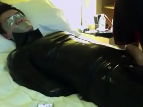 An Asian submissive is tied up and gagged with tape and gets masturbated until he cums.