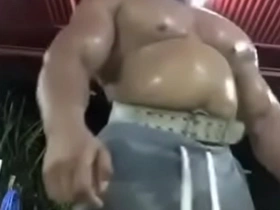 A thick and muscular Thai man shows off his physique in the gym.